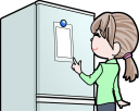 メモを冷蔵庫に貼る女性