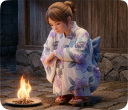 送り火をする浴衣の女性
