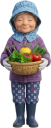 収穫した野菜を持つ農家の女性